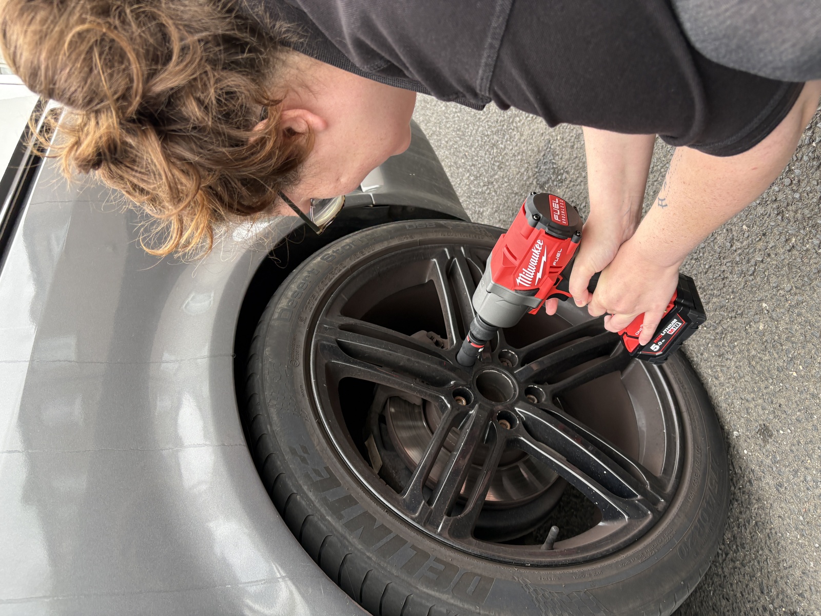 Close up of impact wrench on the alloy wheel during Van 001 build